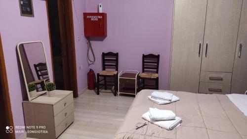 a bedroom with a bed with two towels on it at Porto Sabatiki in Sampatiki