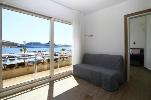 a room with a chair and a large window at Ufuk Otel in Cesme