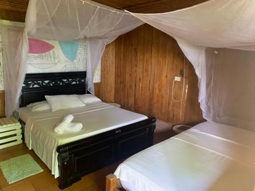 Katil atau katil-katil dalam bilik di Posada Villa Margarita