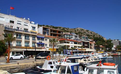 a group of boats docked in a harbor with buildings at Ufuk Otel in Cesme