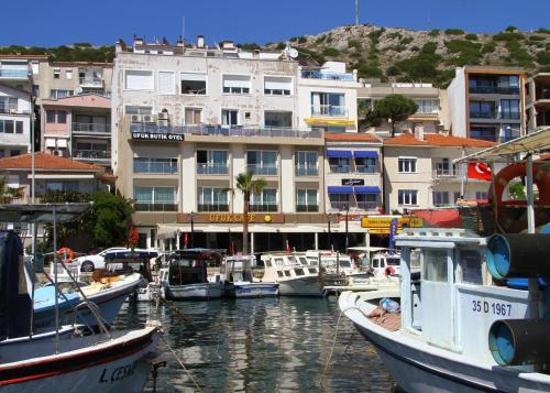 a group of boats docked in a harbor with buildings at Ufuk Otel in Cesme