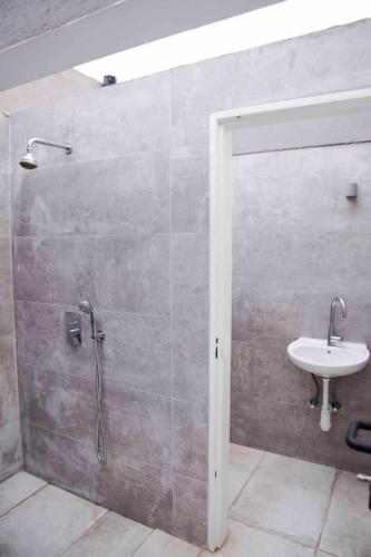 a bathroom with a shower and a sink at Spa Eilat Mountain Lodge in Eilat