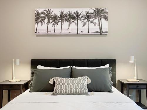 a bedroom with a bed with palm trees on it at Stay at Luna on Callowhill in Philadelphia