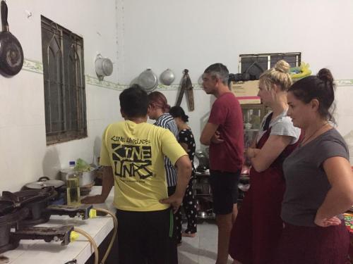 a group of people standing in a kitchen talking at BenTrestay in Giồng Tú Ðiền