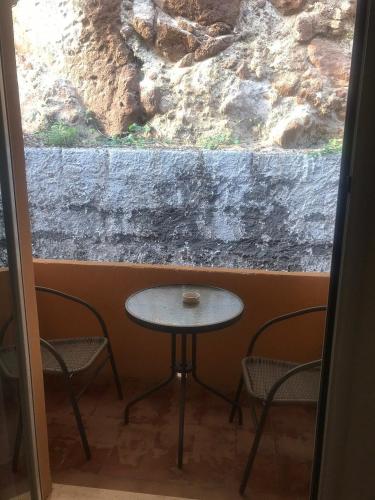 a table and chairs in front of a window at LH Pedraladda Resort in Castelsardo