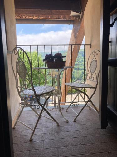 a balcony with two chairs and a table with a view at Locanda del Borgo in Prunetto