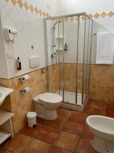 a bathroom with a shower and a toilet and a sink at LH Pedraladda Resort in Castelsardo