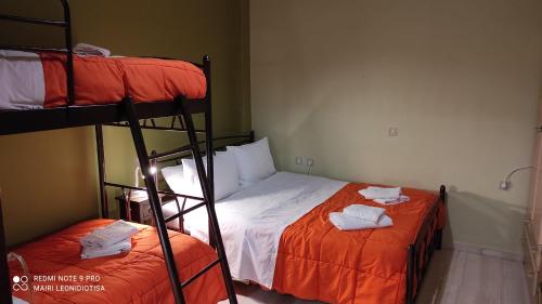 a bedroom with two bunk beds with towels on them at Porto Sabatiki in Sampatiki