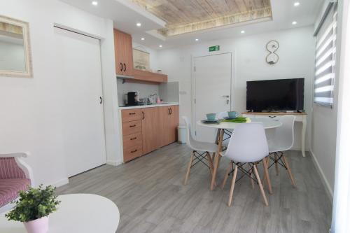 a kitchen and dining room with a table and chairs at GardenLux Vrdnik in Vrdnik