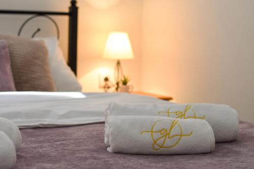 a hotel room with a bed with towels on it at GardenLux Vrdnik in Vrdnik