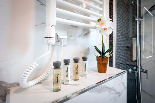 a group of five bottles on a counter in a bathroom at Boutique Residence Arion in Rovinj