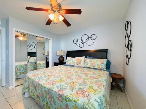 a bedroom with a bed and a ceiling fan at #1203 Lovers Key Beach Club in Fort Myers Beach