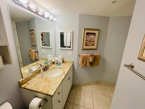 a bathroom with a sink and a mirror at #1203 Lovers Key Beach Club in Fort Myers Beach