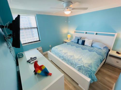 a bedroom with a bed and a toy on a table at #1104 Lovers Key Beach Club Ocean Front in Fort Myers Beach