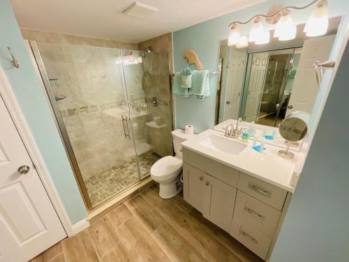 a bathroom with a shower and a toilet and a sink at #1104 Lovers Key Beach Club Ocean Front in Fort Myers Beach