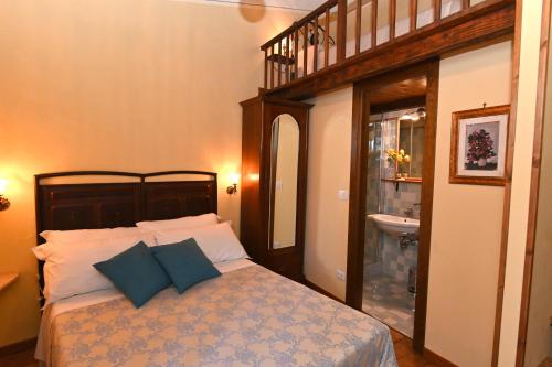 a bedroom with a bed and a bathroom with a sink at il Cantuccio in Pitigliano