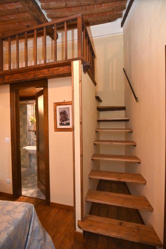 a staircase leading up to a room with a bed at il Cantuccio in Pitigliano