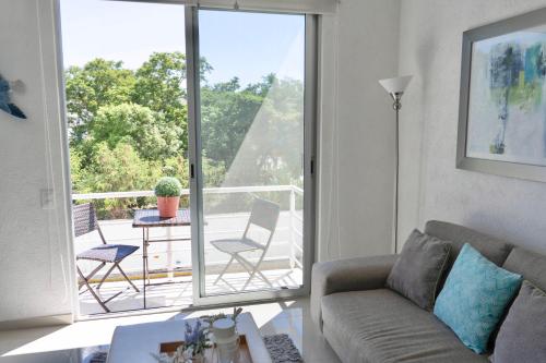 a living room with a couch and a balcony at Yikal Suites by Andiani Travel in Cancún