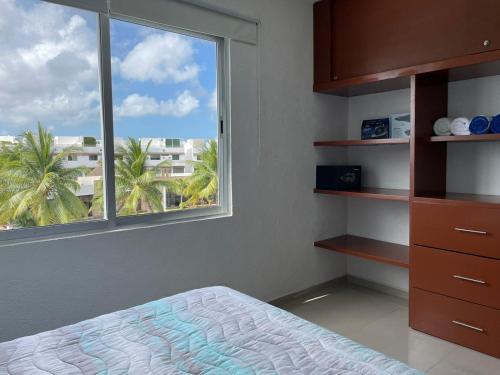 a bedroom with a bed and a large window at Yikal Suites by Andiani Travel in Cancún