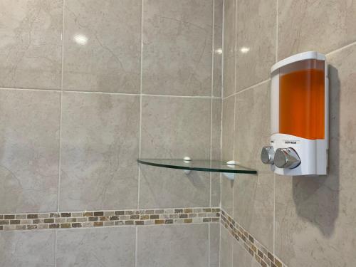 a shower with a glass shelf in a bathroom at Yikal Suites by Andiani Travel in Cancún