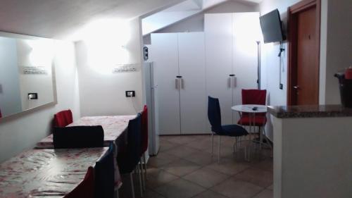 a dining room with tables and chairs and a table at La Quercia Fiorita in Trivolzio