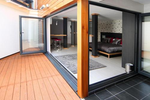 a room with a sliding glass door with a bedroom at Damon’s Hotel in Lincoln