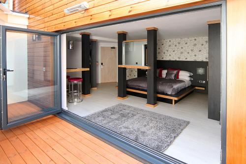 a bedroom with a bed and a sliding glass door at Damon’s Hotel in Lincoln