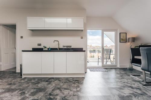 a kitchen with a sink and a counter top at Private Two Bedroom Residence in Southbourne - Private Parking - Off the High Street - Minutes Away from the Beach in Bournemouth