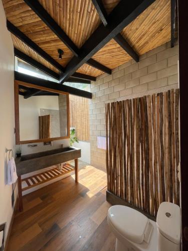 a bathroom with a toilet and a mirror at DIEM Vichayito Beachfront Eco-Luxury in Vichayito