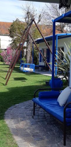a playground with a blue bench in a yard at Mykonos Carmelo in Carmelo