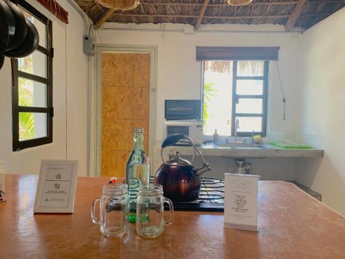 a kitchen counter with a tea kettle and jars on it at Perro Surfero Hotel in Todos Santos