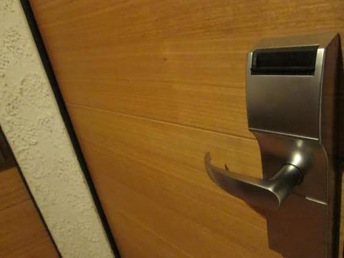 a close up of a door with a metal handle at Hotel Montecarlo Santiago in Santiago