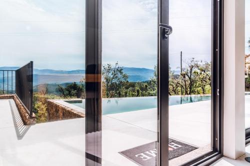 a glass door with a view of a swimming pool at A Casa dos Avós in Celorico de Basto