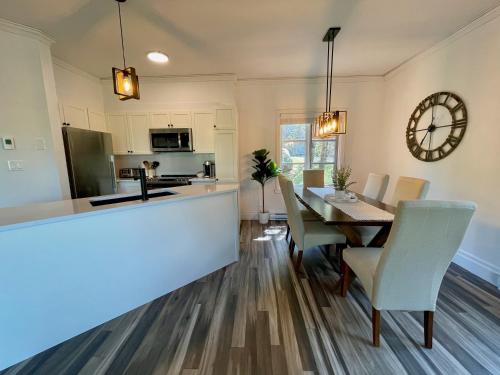 a kitchen and dining room with a table and chairs at Le Plateau East by Tremblant Vacations in Mont-Tremblant