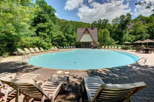 a large swimming pool with chairs and a gazebo at Le Plateau East by Tremblant Vacations in Mont-Tremblant