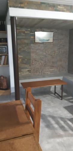 a wooden table and a bench in a room at Mykonos Carmelo in Carmelo
