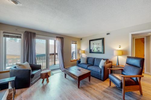 a living room with a couch and chairs and a table at Okemo Mountain Lodge B203 in Ludlow