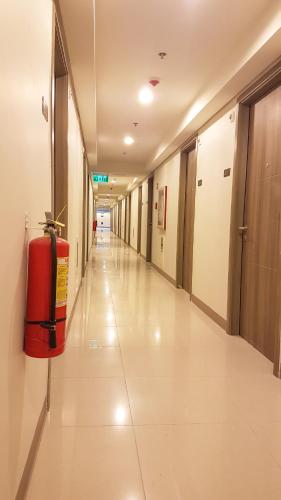 an empty hallway of a hospital with a fire extinguisher at StayInMyCondo - 30th Condo in Pasay with Pool near Airport MOA,CCP & PICC In Pasay in Manila