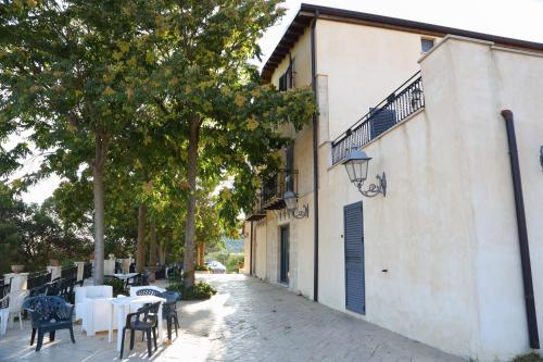 a patio with tables and chairs next to a building at Agriturismo Monticelli in Mussomeli