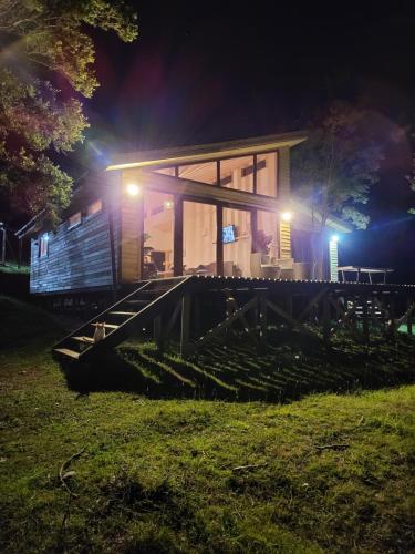 a house with stairs leading to it at night at El refugio del Volcan Osorno in Puerto Clocker