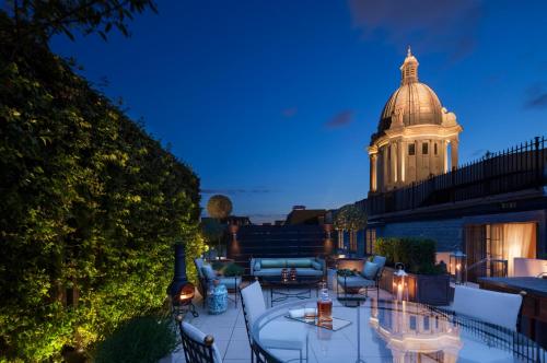 a rooftop patio with a building in the background at Rosewood London in London