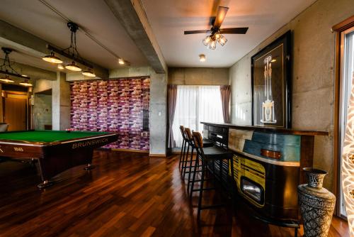 a billiard room with a pool table and a bar at Pine House in Ginoza in Ginoza