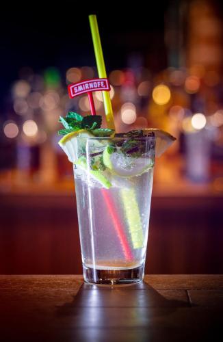 a drink sitting on a table in a bar at Novel Centre Point Hotel in Mağusa
