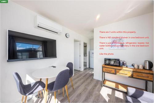 a dining room with a table and chairs and a tv at Tekapo Top 1000 Apartment in Lake Tekapo