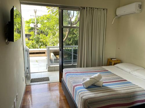 a bedroom with a bed and a window at Vina Rio in Rio de Janeiro