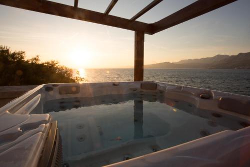 a jacuzzi tub with the ocean in the background at St. Nicholas lighthouse - island of Brač in Pučišća
