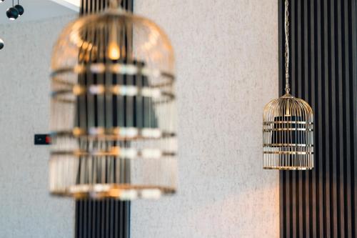two bird cages hanging from a wall at Hotel Millennium by Aycon in Budva