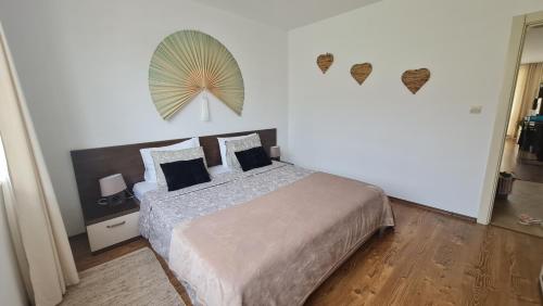 a bedroom with a bed and a fan on the wall at Atia Resot in Chernomorets