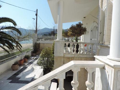a balcony of a house with a white railing at Villa Luxury in Kavala