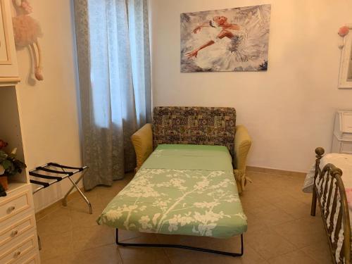 a small room with a bed and a chair at La Maison di Francesco in Genoa